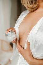 Person holding a SCAR skincare product with a blurred background