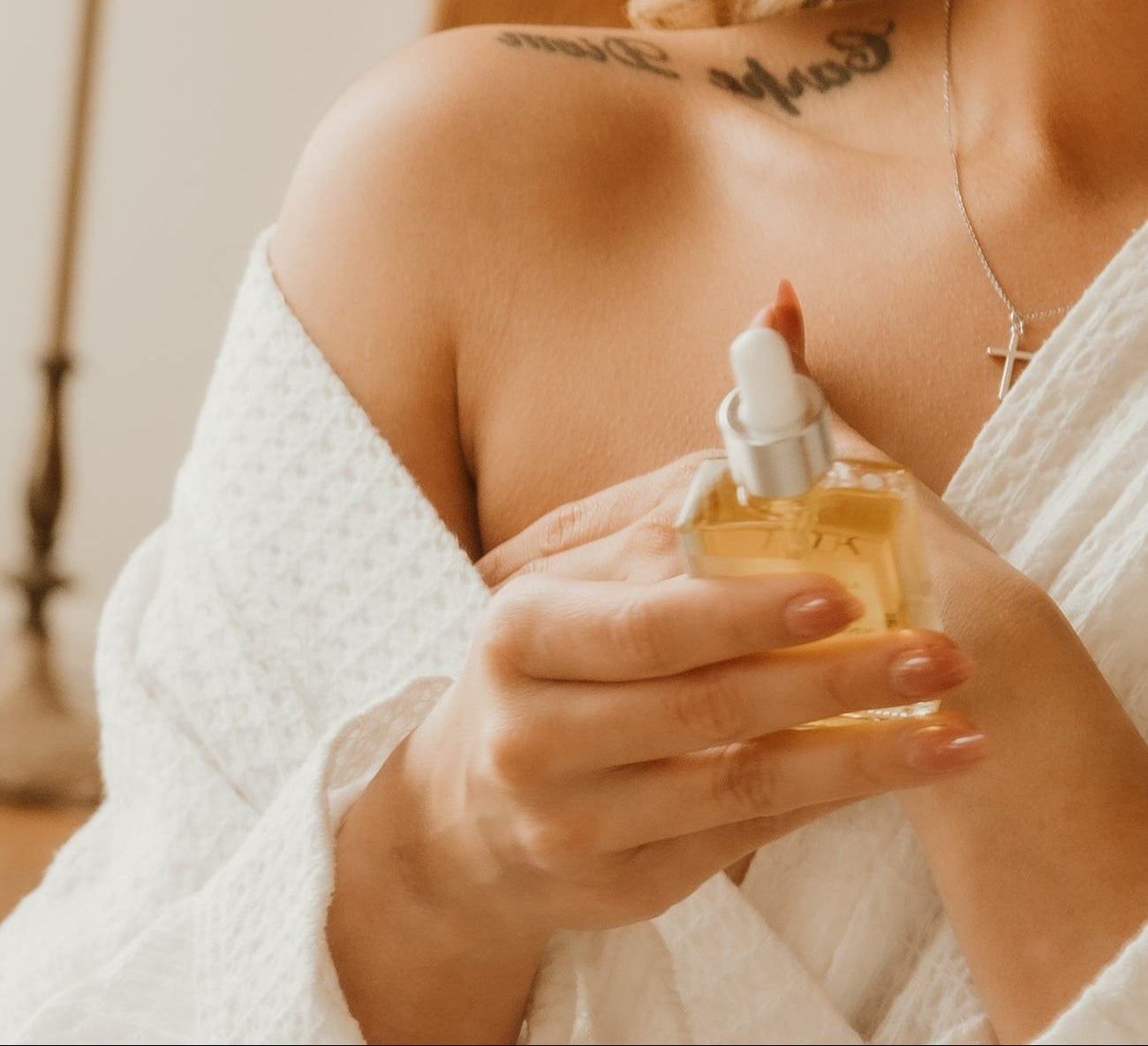 Woman holding a bottle of scare care product with a blurred background