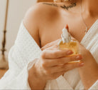 Woman holding a bottle of scare care product with a blurred background